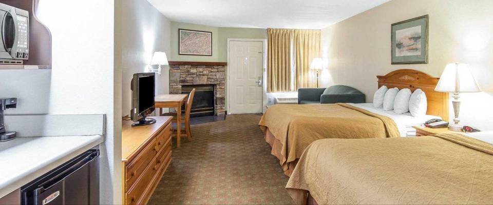 View of a Double Queen Suite  with a sleeper sofa and a kitchenette at the Quality Inn Dollywood Lane in Pigeon Forge