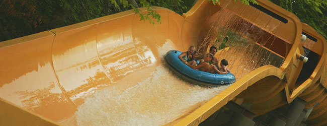 Watch as a family rides in a large 5 person tube down the Big Bear Plunge at Dollywood Splash Country Water Park wide