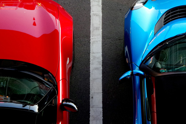 Red and Blue Car parked in a parking lot 600