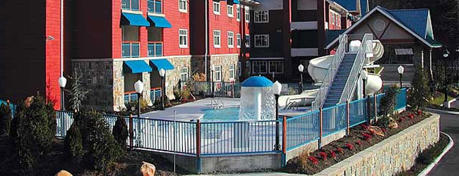 Overview of the Outdoor Pool, zero entry access and water slide at the Fairfield Inn and Suites Gatlinburg North wide