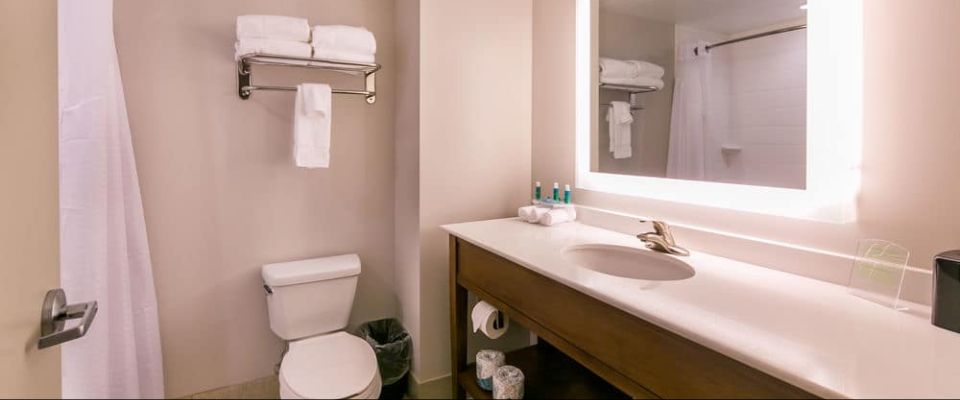Standard Bathroom with Single Sink and long Counter with Tub and Shower Unit at the Holiday Inn Express in Gatlinburg Downtown