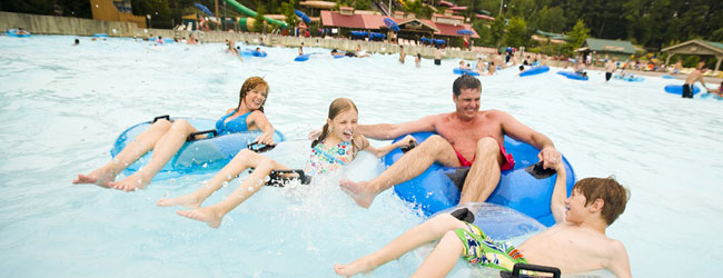 Family enjoying the waves in the massive Mountain Waves Wave Pool at Dollywood Splash Country in Pigeon Forge Tn wide