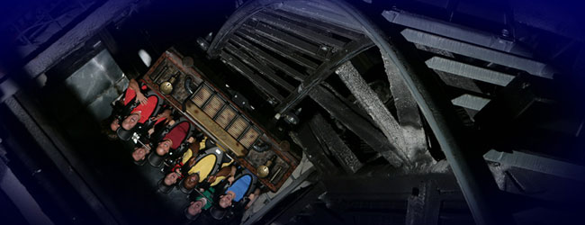 A view of the Mystery Mine Steel Roller Coaster coming out of the Mine with Car upside down at Dollywood wide