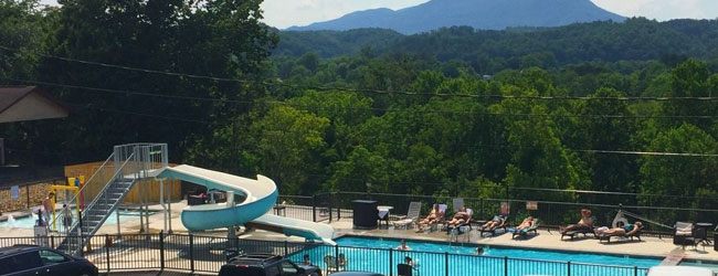 Quality Inn on the Parkway in Pigeon Forge Outdoor Pool with Water Slide and mountains in the background wide