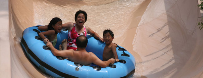 View of Family having a fun time on the Raging River Rapids in Dollywood Splash Country wide