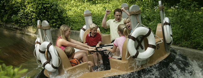 Family getting soaked in the Water Rafting Ride River Rampage at Dollywood wide