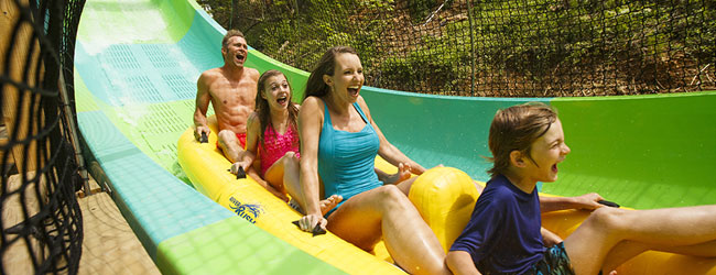 Family zipping along the RiverRush Water Coaster at the Dollywood Splash Country Water Park in Pigeon Forge Tn wide