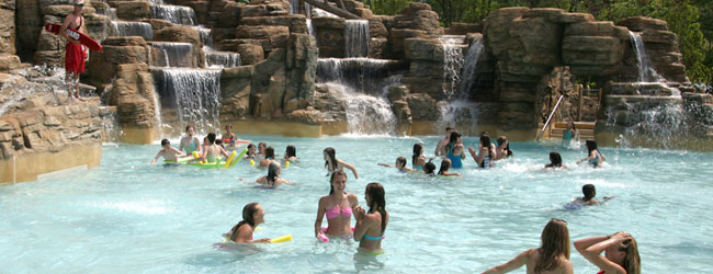 The Cascades features a large pool with slides and a backdrop of beautiful waterfalls in Dollywood Splash Country Water Park wide