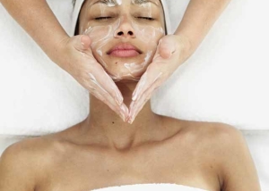 female on table lying on back and having facial spa treatment